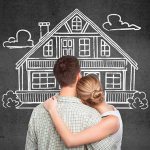 a girl and a guy stand in front of a painted house