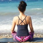 Girl meditating by the sea