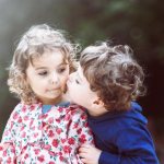 Boy kissing girl on the cheek