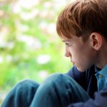 boy sitting alone