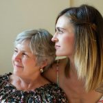 mother and daughter looking out the window