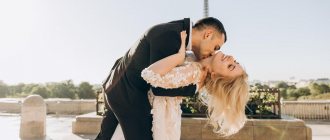 A man kisses a girl in a white dress on the neck