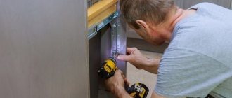 man repairing kitchen cabinet