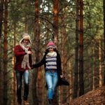 guy and girl walking in the forest