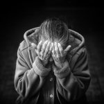 an elderly woman grieves after the death of her husband